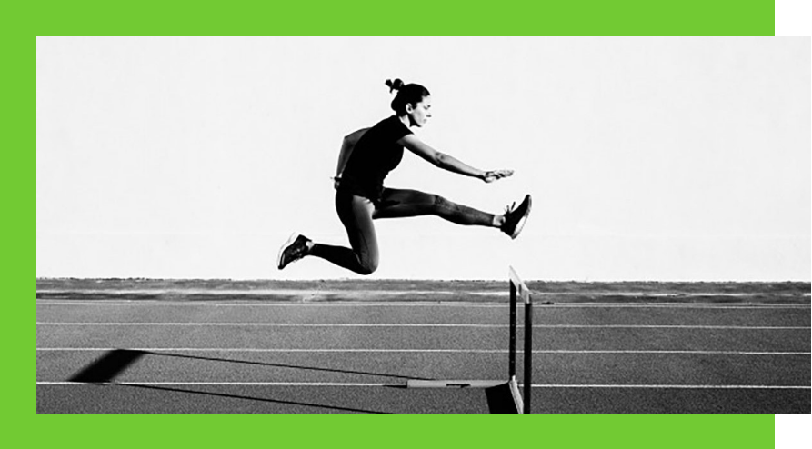 Female athlete leaping over a hurdle